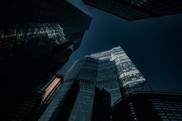 Low perspective over tall glass buildings in London