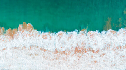 A roaring wave crashes into the deep waters, creating a mesmerizing display of power and beauty,...