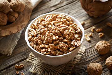 Walnut kernels in a bowl on a rustic table