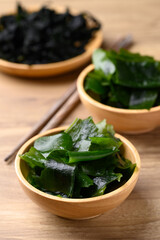 Fresh Wakame seaweed or sea mustard in wooden bowl