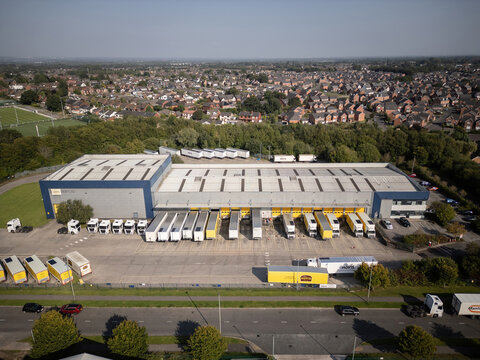 HAYDOCK, UK - SEPTEMBER 07, 2024: Drone aerial view of Hovis bread bakery warehouse and vehicles in England