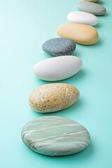 Stacked stones in balance on mint background