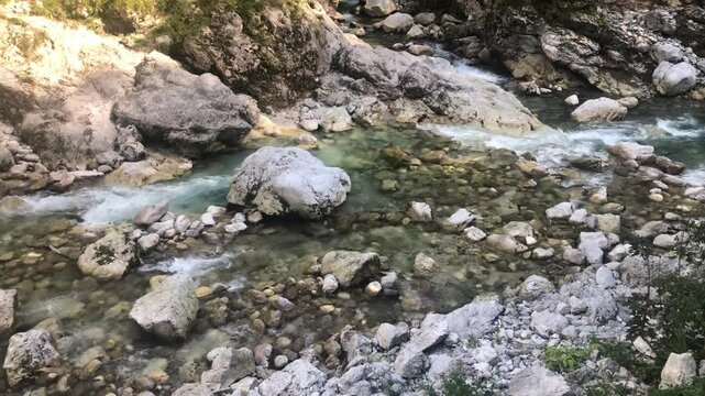 Beautiful Clear Water of the Soča River Flowing through the Rocks in the Julian Alps during a Summer Day. Tolmin Gorge, Slovenia