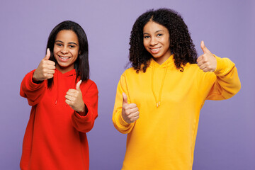 Two young happy little kid teen girls women they wear red yellow hoodie casual clothes showing...