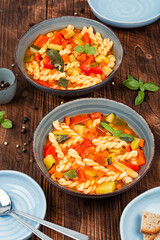 Italian minestrone soup on wooden background.