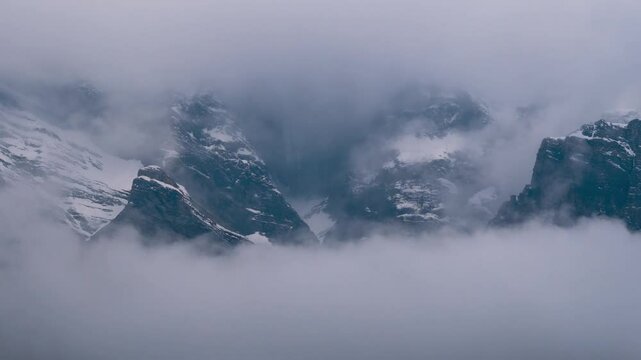 Storm clouds roll over snow mountains during stormy day in winter at Lahaul, Himachal Pradesh, India. 4K Time Lapse of dark clouds rolling over mountains. Nature landscape. 