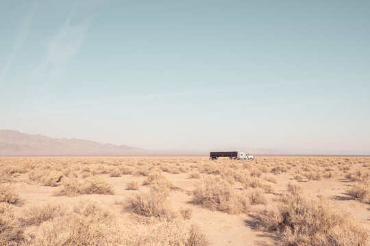 Lonely Truck Journeying Through Death Valley Desert