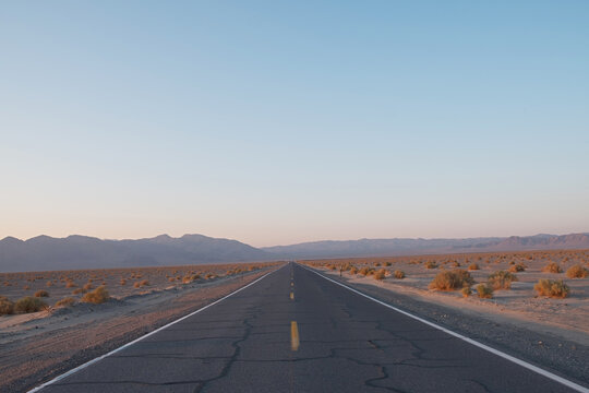 Endless road through Death Valley at twilight