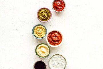 Many different sauces in bowls. Food or cooking background