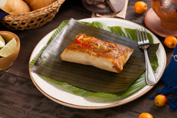 Guatemalan food dish. Corn tamale, made with corn flour, tomato sauce, spices and pork.