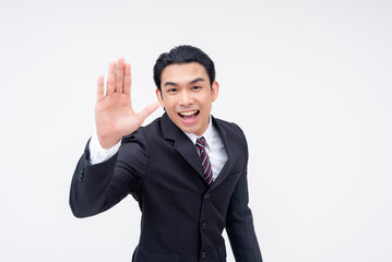 An enthusiastic young asian businessman giving a hi-five. A man in a suit and tie beaming with optimism, isolated on a white background.