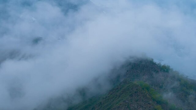 Time lapse video clouds over Himalaya mountains during monsoon season at Lahaul, Himachal Pradesh, India. Clouds roll over the snowy mountains ridge. Time-Lapse. Time-lapse footage of earth landscape 