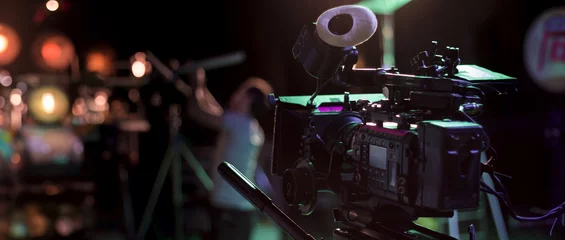 cinema camera on the set of a film. Professional video camera and movie lighting crew with copy space. © OneClic