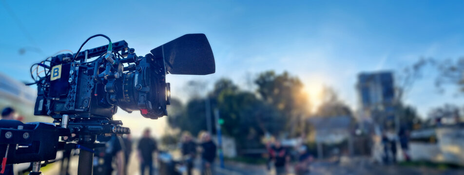 Video camera on a movie set in a street. Panoramic view and copy space for film industry banner background
