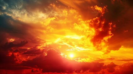 Obraz premium The sun sets in a blaze of fiery colors, with the sky transitioning from bright yellow to deep crimson, creating a striking and vivid sunset scene.