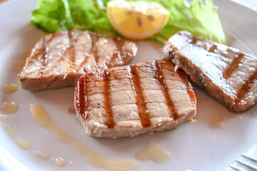 Grilled tuna steak. Fried fish served in a restaurant. Delicious fish steak.