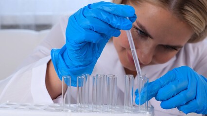 professional scientist takes a sample for a medical experiment. A research chemist works in a...