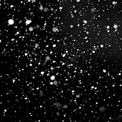 Snow falling against a dark sky