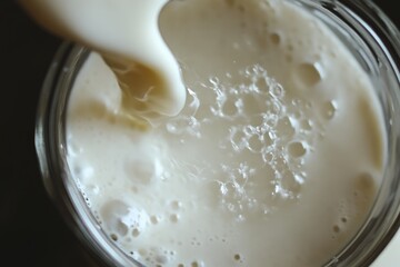 Milk Stream Flowing from Jar to Glass
