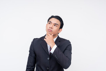 A young and introspective asian business executive pondering some decisions to make. Isolated on a white background.