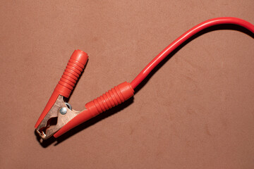 Crocodile clip on brown background