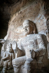Ancient Buddha statues inside the Yungang Grottoes, which located near Datong in Shanxi Province, China, are a UNESCO World Heritage Site known for their stunning Buddhist sculptures. 