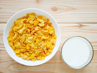 Golden cornflakes cereal and a glass of milk