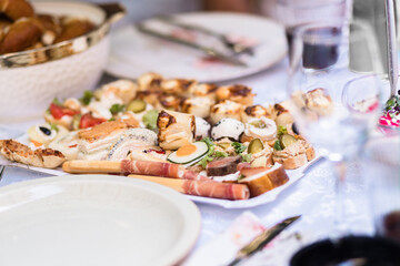 Assorted gourmet appetizers arranged elegantly on a platter during a festive gathering