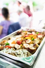 Delicious assortment of roasted meats and vegetables served at a festive outdoor gathering in a sunny garden setting