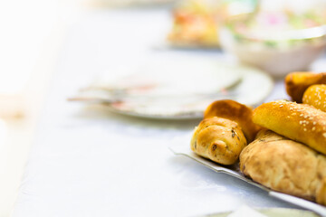 Freshly baked bread and pastries displayed on a dining table in a cozy setting during a weekend brunch gathering