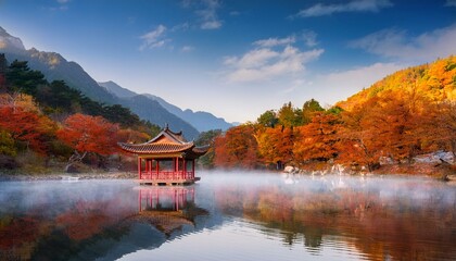 Obraz premium Serene Autumn Chinese Mountain Landscape with Traditional Pavilion and Misty Morning Reflection