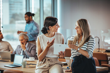 Colleagues Engaging in a Productive Office Discussion with Technology