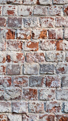 Ancient ruined brick wall with paint residue. Brick weathering. Selective focus