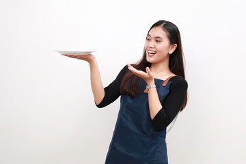 Chef cook holding an empty plate. Portrait of asian chef cook showing plate. Restaurant chef is...