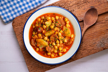 Delicious dish of braised chickpeas with spicy chorizo. Top view food table.