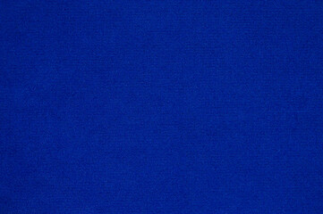 A close-up of a blue velvet fabric. Blue textured background image.