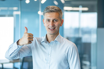 Confident Businessman Giving Thumbs Up