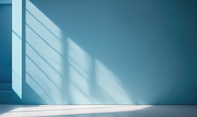 Sunlight streams through a window, casting a pattern of light and shadow on a light blue wall