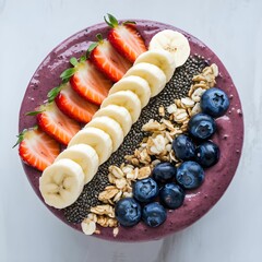 Healthy breakfast, fresh fruits and superfoods. natural ingredients. banana, strawberries, blueberries, chia seeds, granola, and a drizzle of honey.