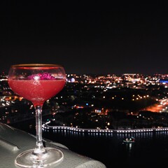 Cocktail with a view of the skyline at night.