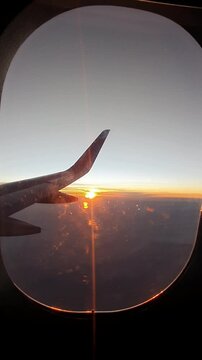View from plane window sunshine reflections vertical video