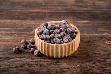 Roasted hazelnuts in shell on old wooden table