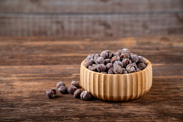 Roasted hazelnuts in shell on old wooden table