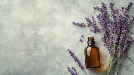 Bottle of essential oil and lavender flowers on light stone table