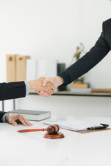 A professional handshake signifies successful agreement in legal setting.