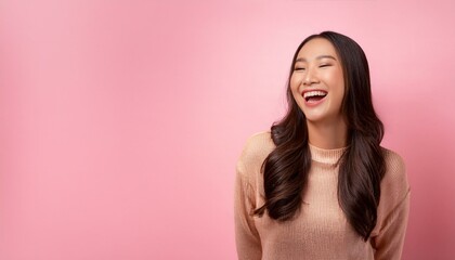 Fototapeta premium Asian woman laughing, Portrait of a beautiful young Asian woman laughing joyfully, isolated on a soft pink background, beauty and radiant smile create a cheerful and uplifting mood, happiness 