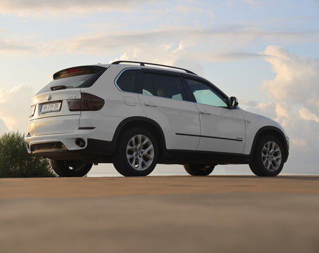BATUMI, GEORGIA - 04 SEPTEMBER 2024: White luxury SUV car, BMW X5, at Road on sunset sky background. facelifted BMW X5  car is parking along the highway.  famous German worldwide brand. X drive 35i