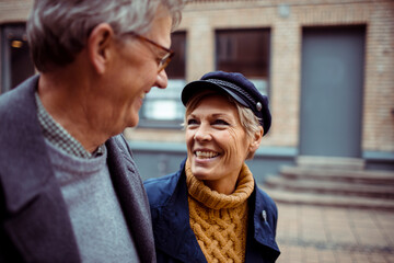 Elderly couple sharing a joyful moment on a city walk