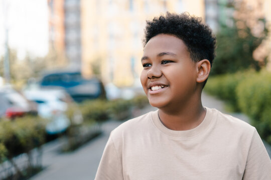 Happy african american boy smiling outdoors in the city
