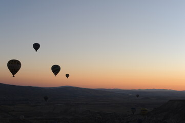 Beautiful view of hot air balloons floating in the air at sunrise with clear sky in Cappadocia, Turkey (Türkiye)